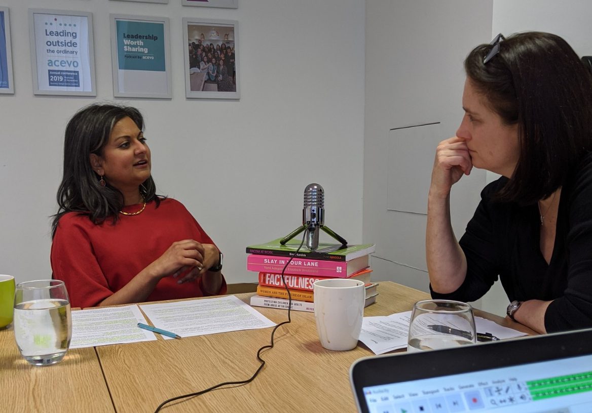 Aleema Shivji and Vicky Browning having a chat which is being recorded, there is a microphone between them