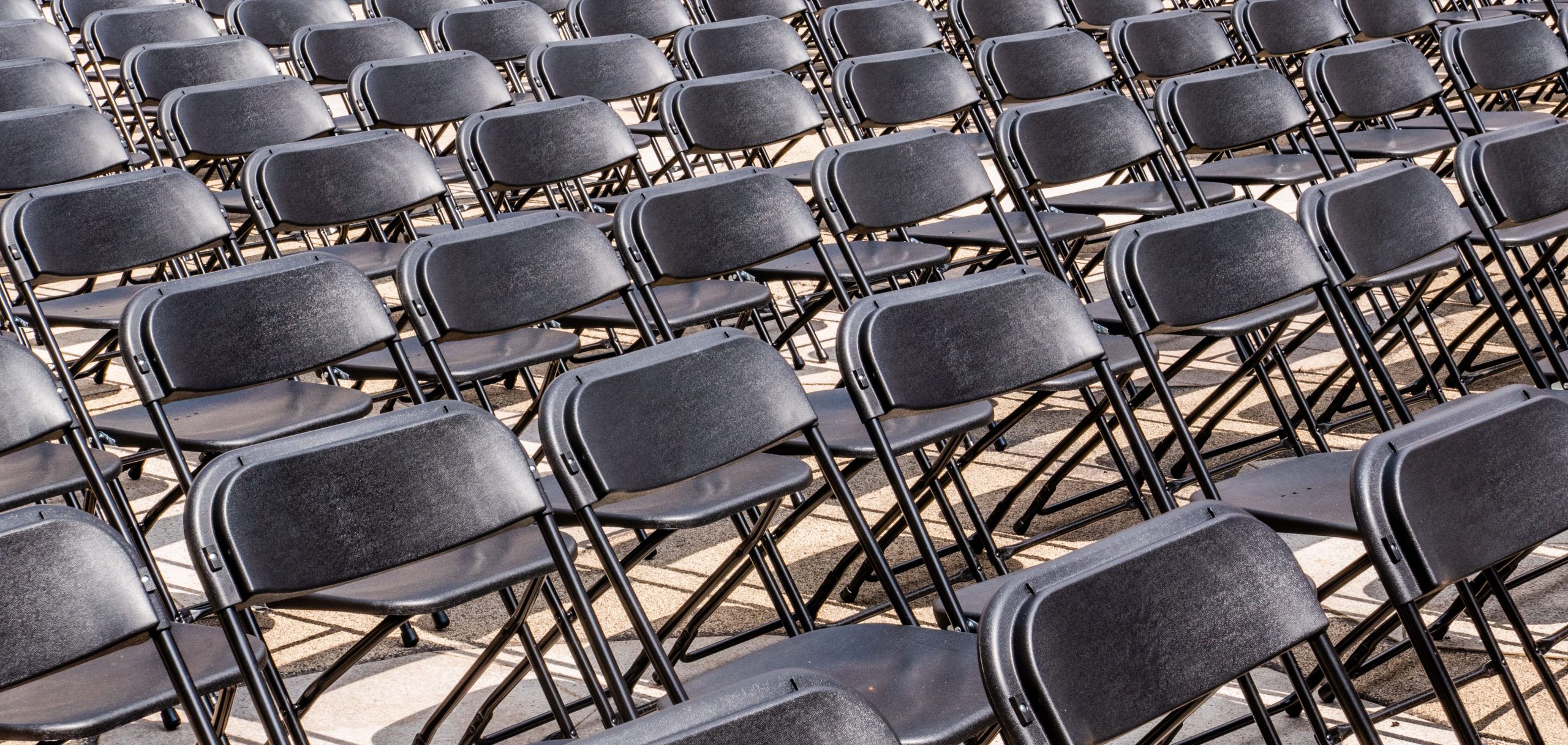 rows and rows of black chairs, as if they are organised for a mass event