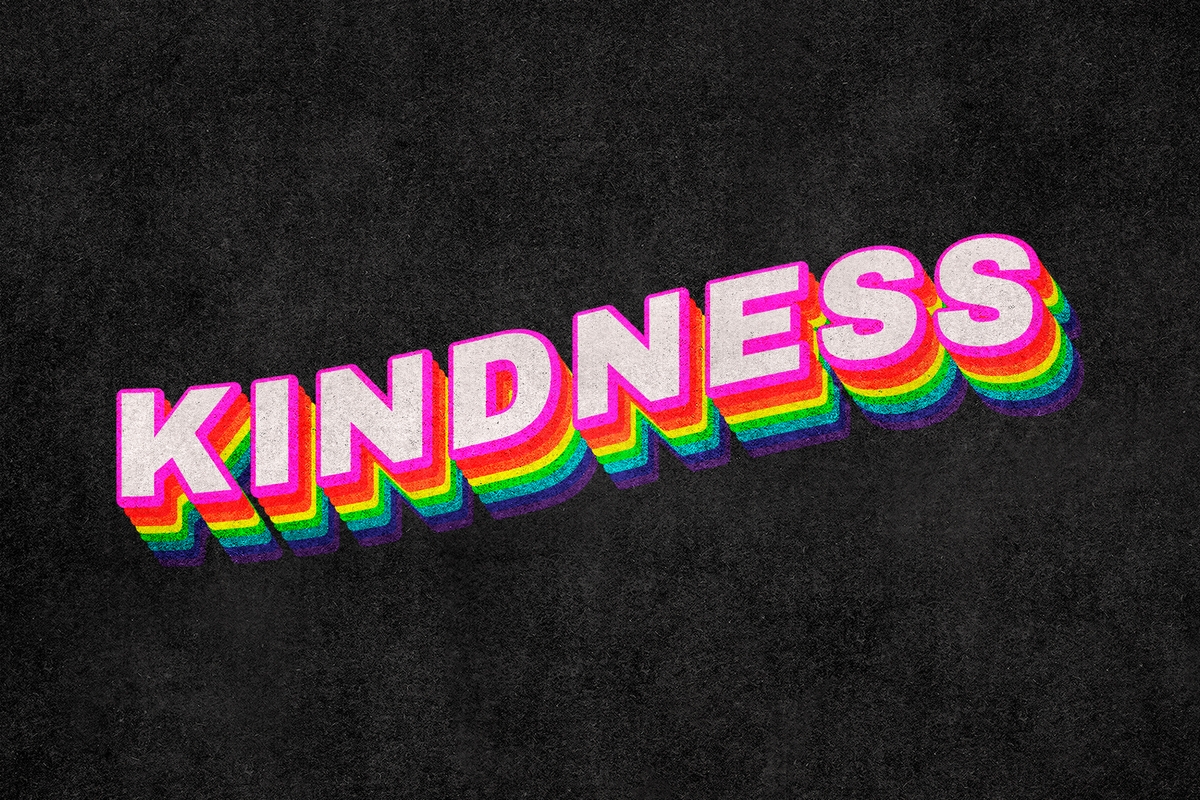 Kindness written in pink over a black background