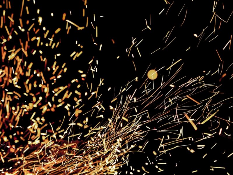 sparkles from a firepit against a dark background
