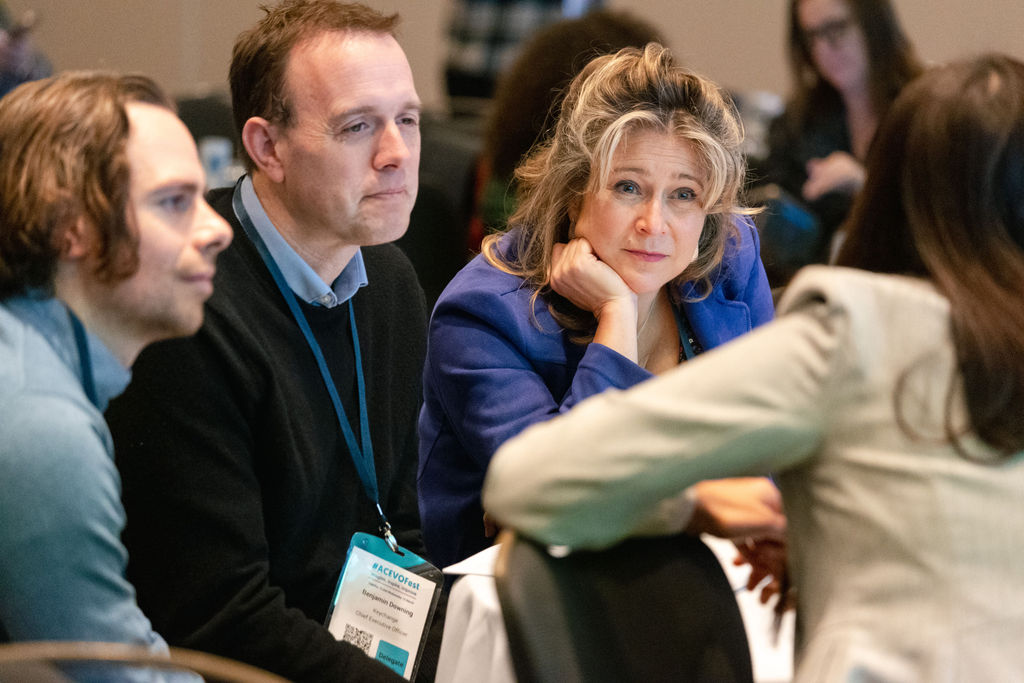 4 people having chat around a table