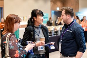 three people attending a conference having a chat