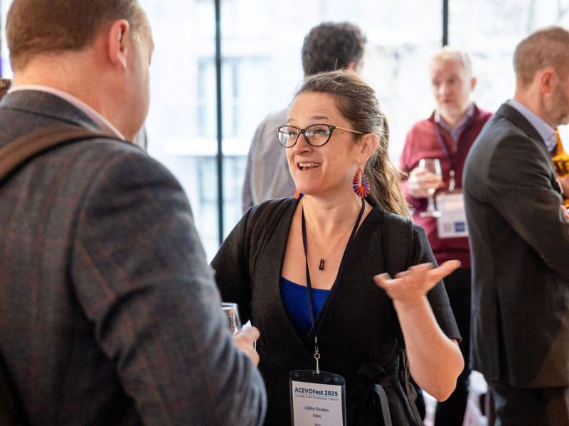 a woman and a man having a lively chat at a networking session