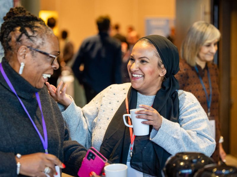 two women having a lively chat, they're smiling at each other